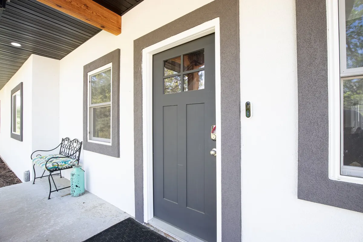 This interior image highlights the front door, bench seating, and decorative accents, offering a glimpse into the thoughtful design and comfort awaiting guests. The setup suggests ease of entry and organized arrivals.